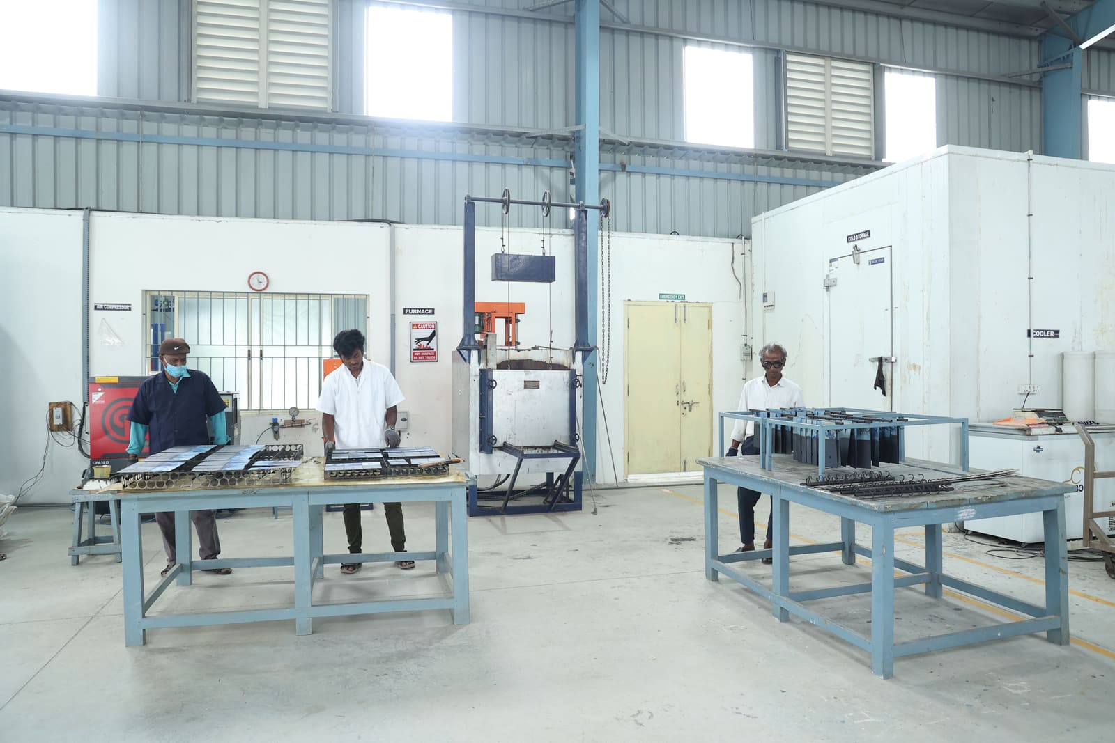 Technicians preparing titanium electrodes on the shopfloor